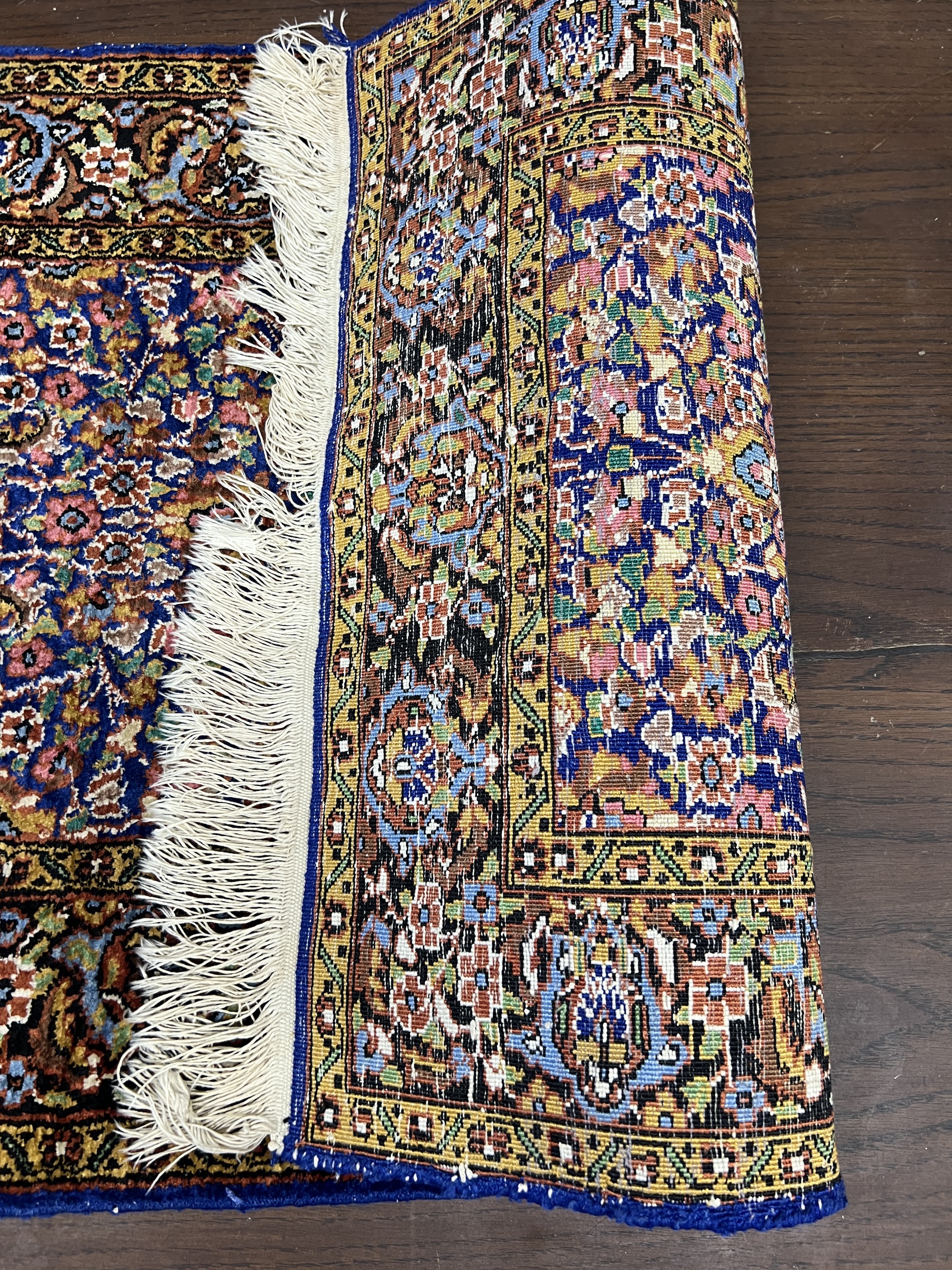 A North West Persian part silk blue ground rug, 89cm x 58cm